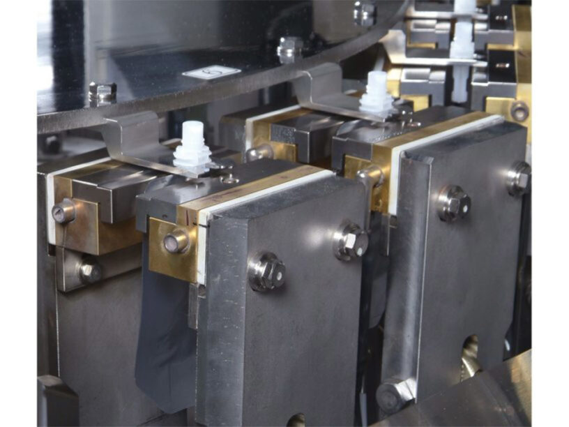 Zoomed in view of the TX-100SP-1 center spout inserter machine