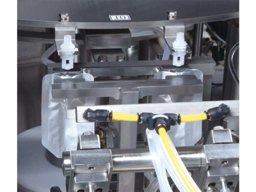 Close up of the TX-100SP-1 center spout inserter machine